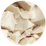 Close-up circular view of pale cream-colored solid Illipe Nut Butter chunks.