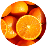 A circular close-up of bright orange fruits, including whole oranges and a cut orange showing the juicy segmented interior, on a white background.