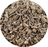 A close-up circular view of a pile of dried brown Valerian roots.